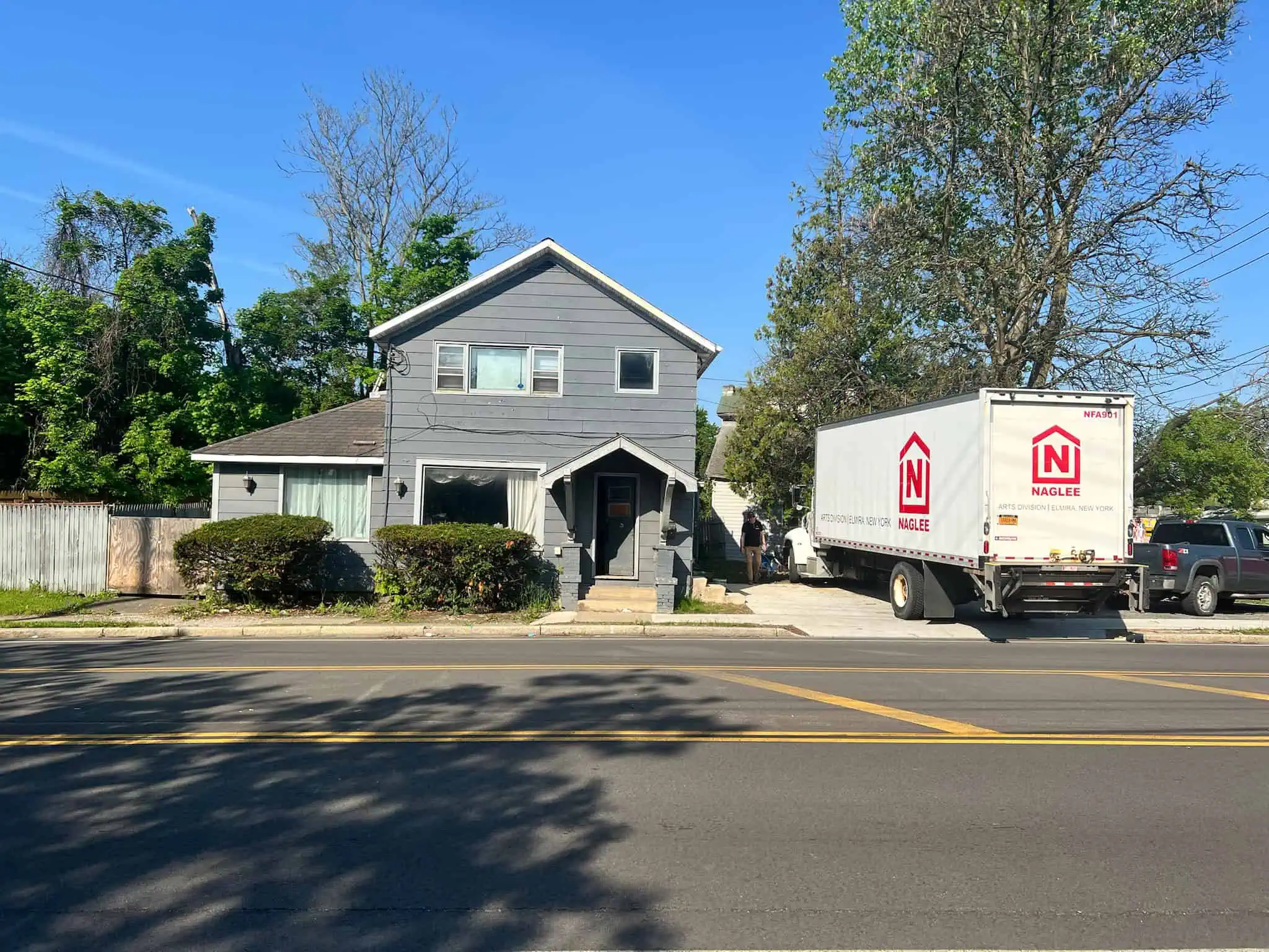 Naglee moving truck parked outside a two-story home