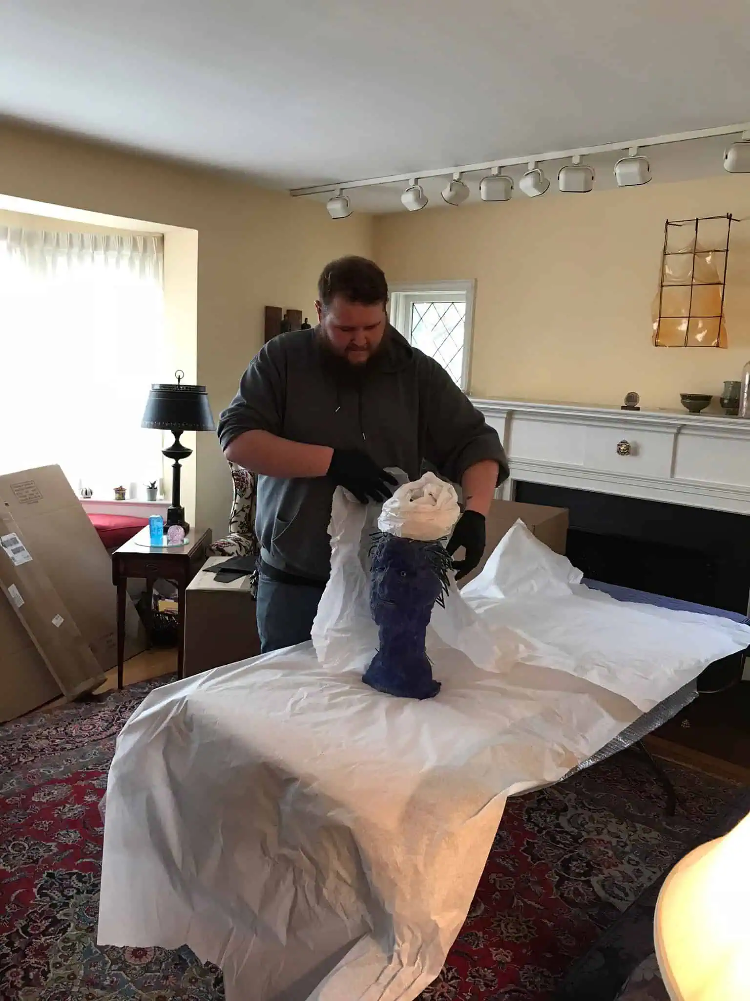 Naglee mover wrapping kitchen contents for a move [verify]